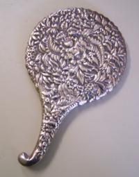 Victorian sterling silver hand mirror with embossed design c1880