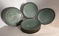 Set of eight studio pottery dinner plates in celadon green