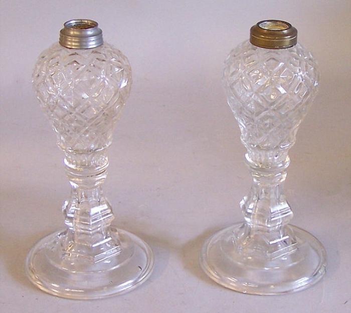 Pair glass oil lamps in diamond pattern on candlestick bases