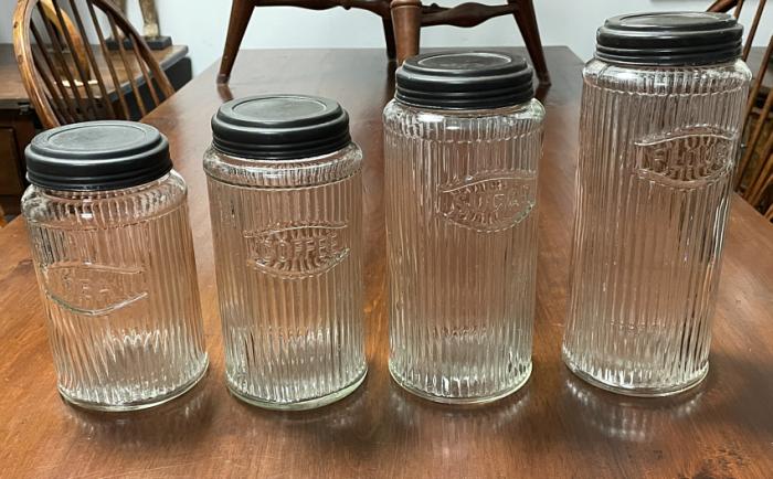 Set of antique kitchen canisters with tin tops