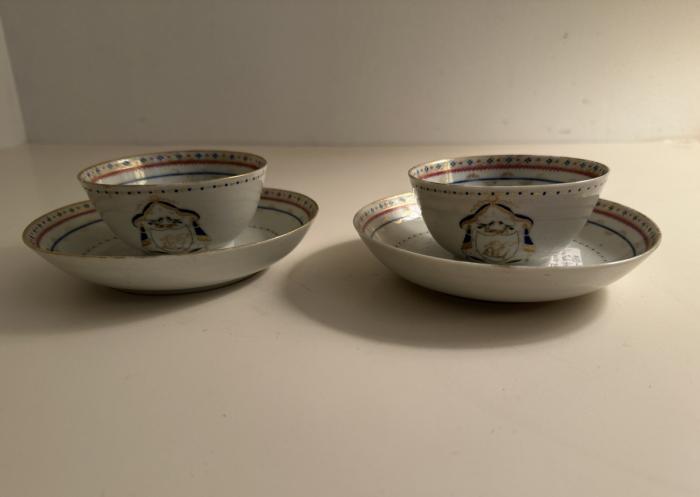 China Trade armorial pair of porcelain cups and saucers